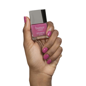 butter LONDON - Dearie Me (Deep Pink) Patent Shine 10X Nail Lacquer - Lifestyle Image - Full White Background.