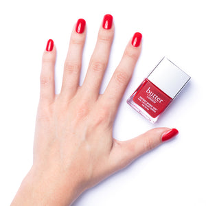butter LONDON - Her Majesty's Red (Red) Patent Shine 10X Nail Lacquer - Lifestyle Image - Full White Background.