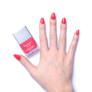 butter LONDON - Flusher Blusher (Bright Pink) Patent Shine 10X Nail Lacquer - Lifestyle Image - Full White Background.