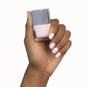 butter LONDON - Sandy Bum (Light Pink) Patent Shine 10X Nail Lacquer - Lifestyle Image - Full White Background.