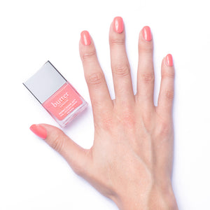 butter LONDON - Trout Pout (Coral) Patent Shine 10X Nail Lacquer - Lifestyle Image - Full White Background.