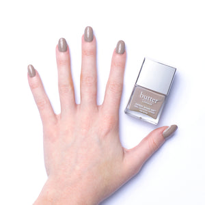 butter LONDON - Yummy Mummy (Light Brown) Patent Shine 10X Nail Lacquer - Lifestyle Image - Full White Background.