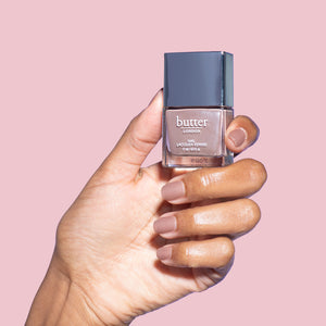 butter LONDON - All Hail the Queen (Nude Shimmer) Patent Shine 10X Nail Lacquer - Lifestyle Image - Full White Background.